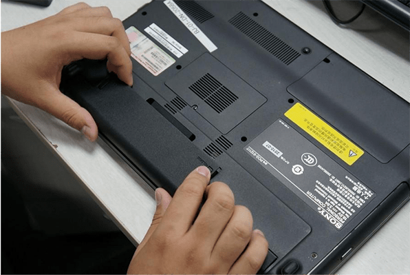 remove the battery at the bottom of the laptop
